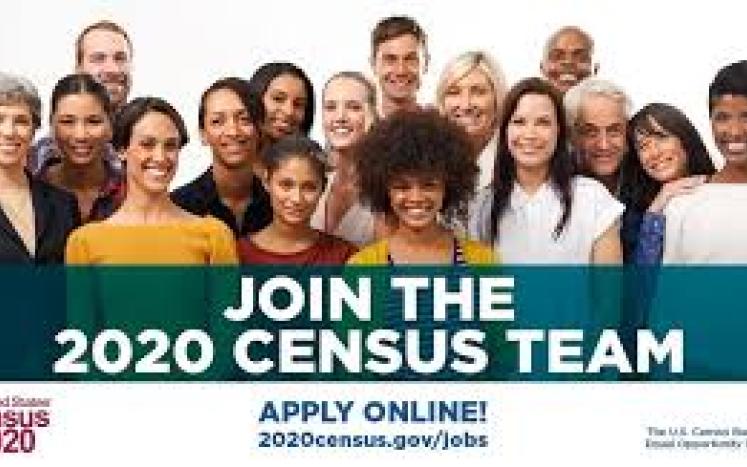 Image of census workers with a recruitment banner